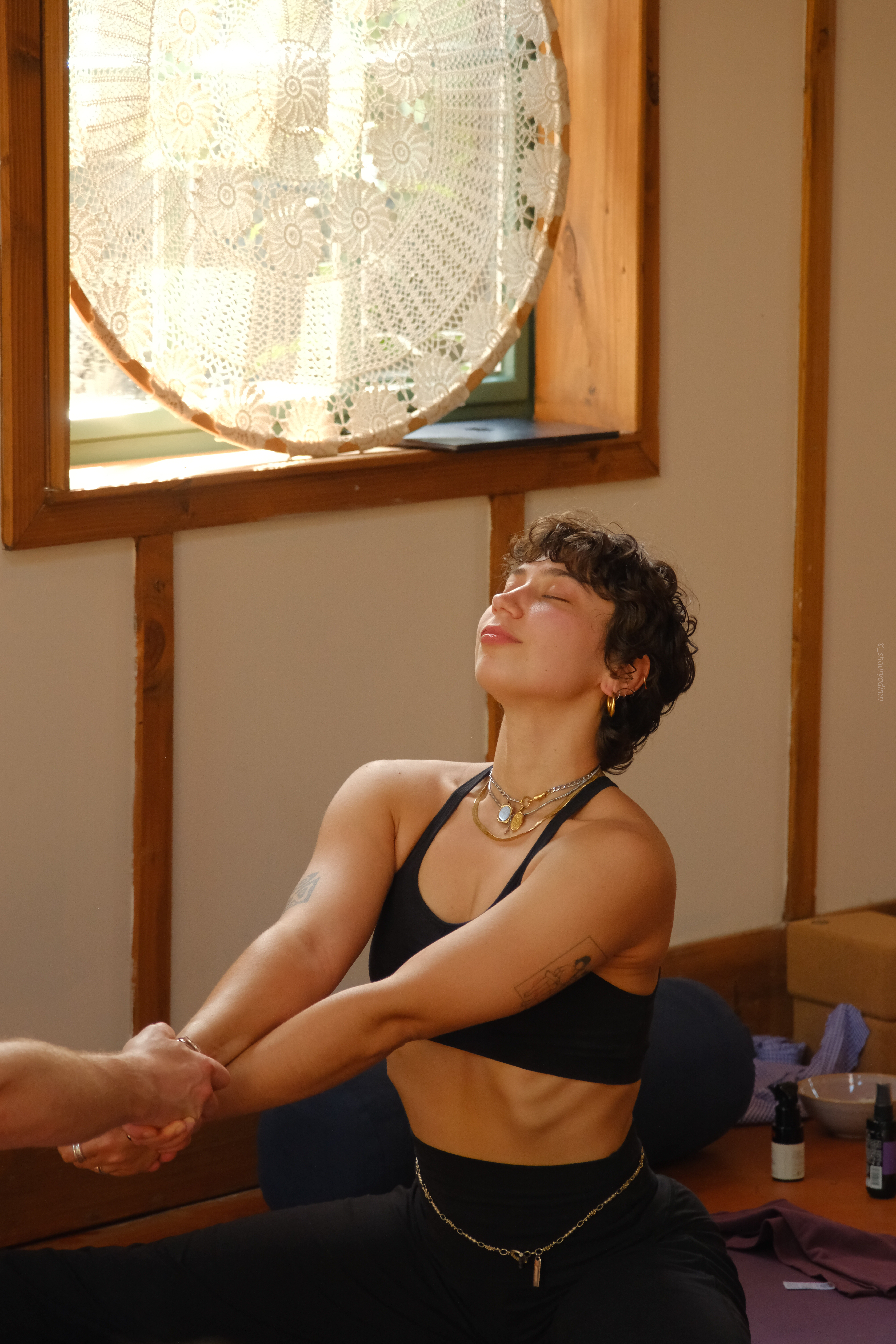 Angèle, seated, eyes closed